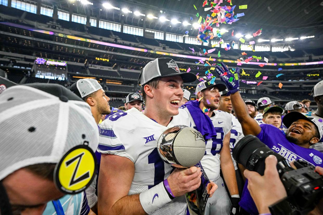 Kansas State quarterback Will Howard (18) holds the Big 12 championship trophy after last year's overtime victory over TCU in Arlington, Texas.