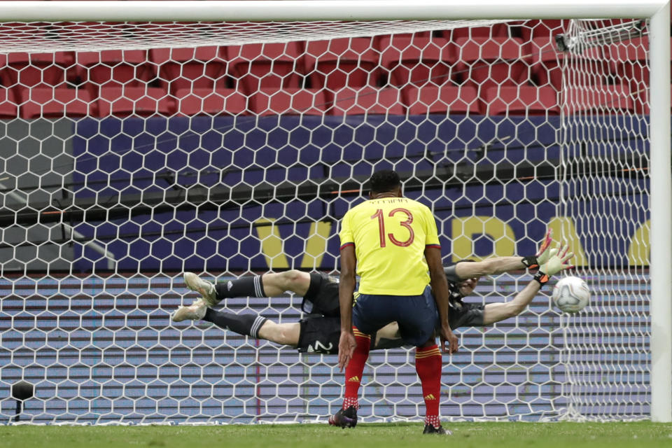 Argentina's goalkeeper Emiliano Martinez blocks a penalty shot by Colombia's Yerry Mina during the penalty shootout in a Copa America semifinal soccer match at the National stadium in Brasilia, Brazil, Wednesday, July 7, 2021. (AP Photo/Eraldo Peres)