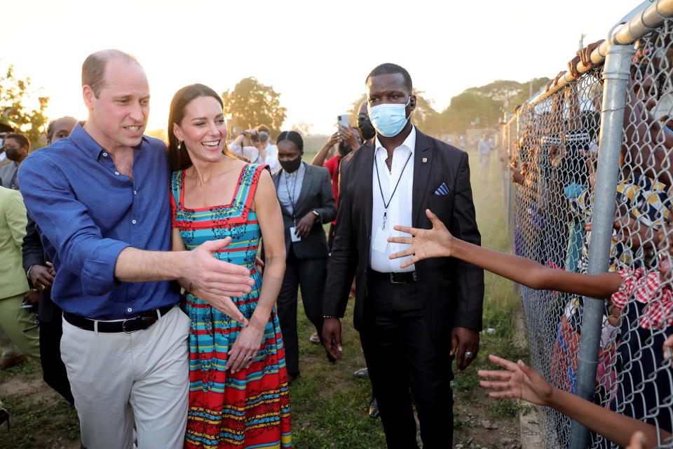 Prince William and Catherine, Duchess of Cambridge, shake hands with children during a visit to Trench Town, the birthplace of reggae music, on day four of the Platinum Jubilee Royal Tour of the Caribbean in Kingston, Jamaica, March 22, 2022. / Credit: Chris Jackson/Pool/REUTERS