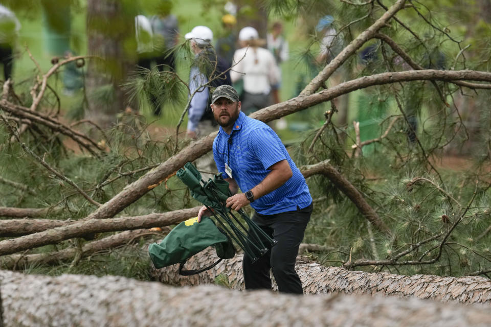 Authorities investigate the scene where trees fell on the 17th hole during the second round of the Masters golf tournament at Augusta National Golf Club on Friday, April 7, 2023, in Augusta, Ga. (AP Photo/Mark Baker)