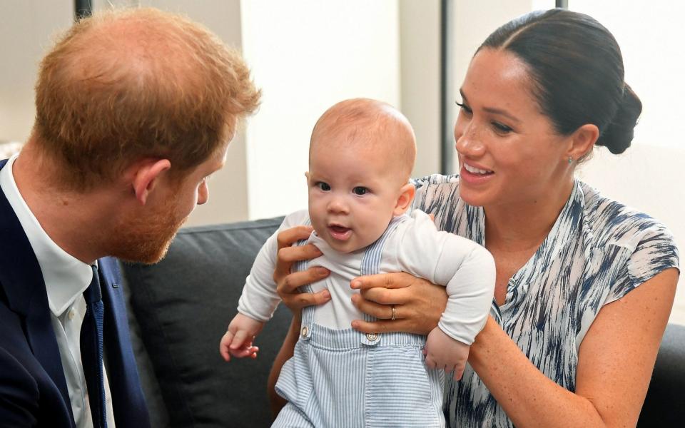 The Duke and Duchess of Sussex holding their son Archie. - PA