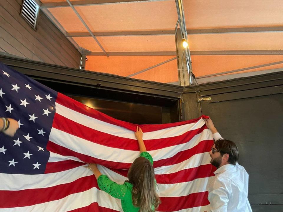 McCrory campaign staff hang an American flag at Selwyn Avenue Pub, where the former governor was having a campaign event.