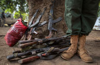 <p>A former child soldier stands next to rifles during the release ceremony for child soldiers in Yambio, South Sudan on Feb. 7, 2018. (Photo: Stefanie Glinski/AFP/Getty Images) </p>