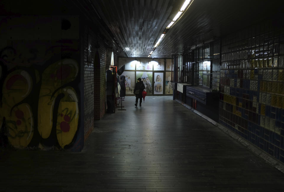 A woman walks through an underground passage during a rainy day in Belgrade, Serbia, Wednesday, Feb. 5, 2020. Weather forecasts predict changeable weather during the next few days. (AP Photo/Darko Vojinovic)