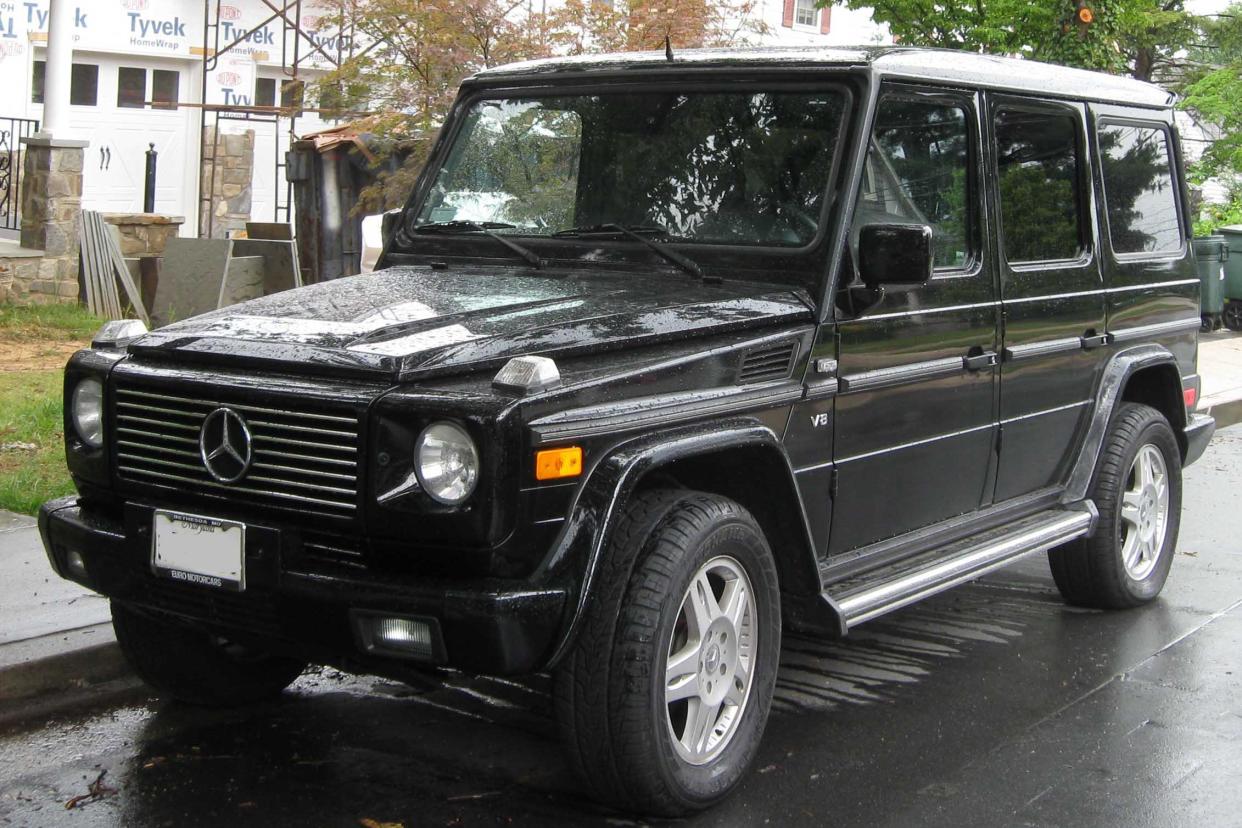 Mercedes-Benz G-Class parked on a street after rain.