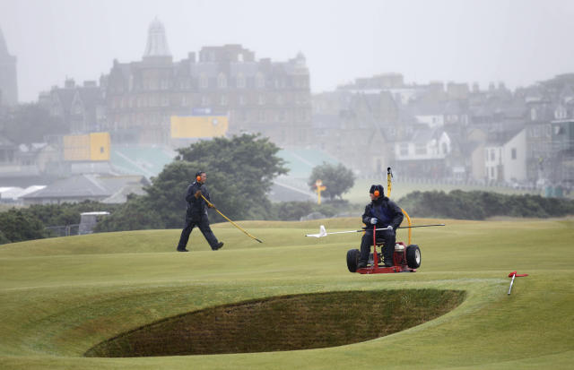 FILE - Workers are shown tending to the 17th green on the Old Course, St Andrews, Scotland, Saturday, July, 10, 2010. The Open Championship returns to the home of golf on July 14-17 to celebrate the 150th edition of the sport's oldest championship, which dates to 1860 and was first played at St. Andrews in 1873. (AP Photo/Peter Morrison, File)