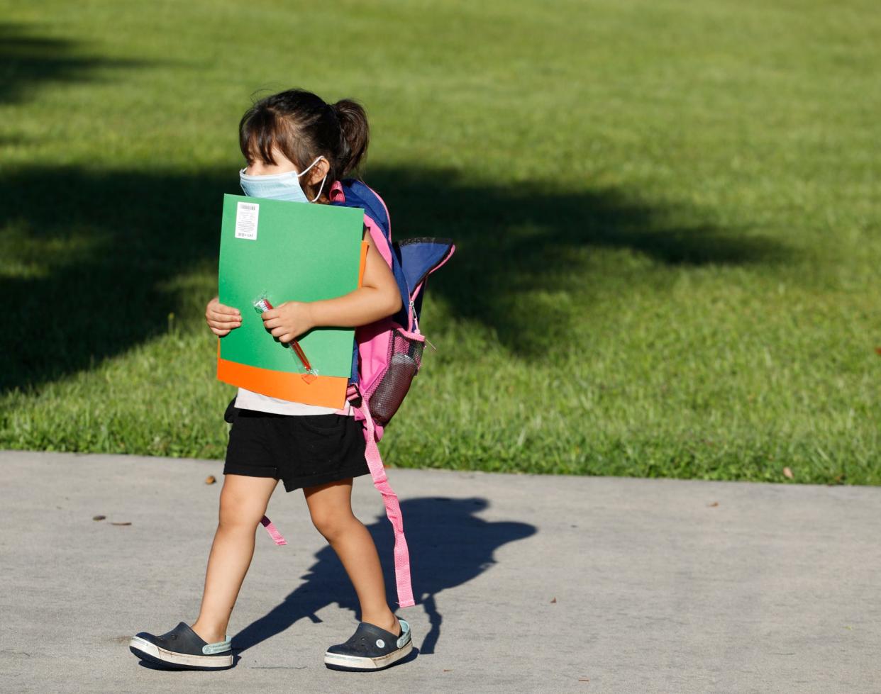 A student holds onto her new school supplies in DeLand at the annual Mayor's Backpack Giveaway at Earl Brown Park in 2021.