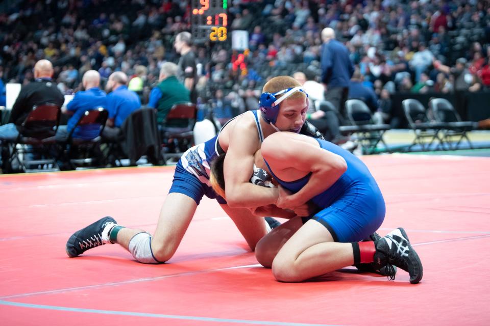 Pueblo Central's Genaro Pino cranks the neck of Florence's Skyler Davis during their 160-pound first round matchup in the Class 3A state tournament at Ball Arena on Thursday, Feb. 16, 2023.