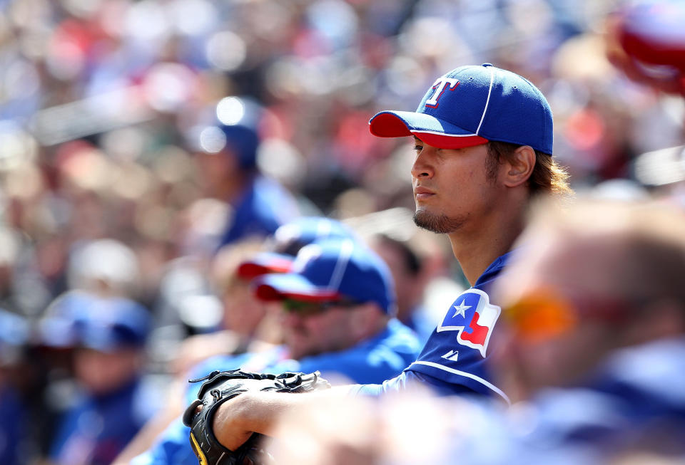 PEORIA, AZ - MARCH 07: Starting pitcher Yu Darvish #11 of the Texas Rangers watches from the dugout during the spring training game against the San Diego Padres at Peoria Stadium on March 7, 2012 in Peoria, Arizona. (Photo by Christian Petersen/Getty Images)