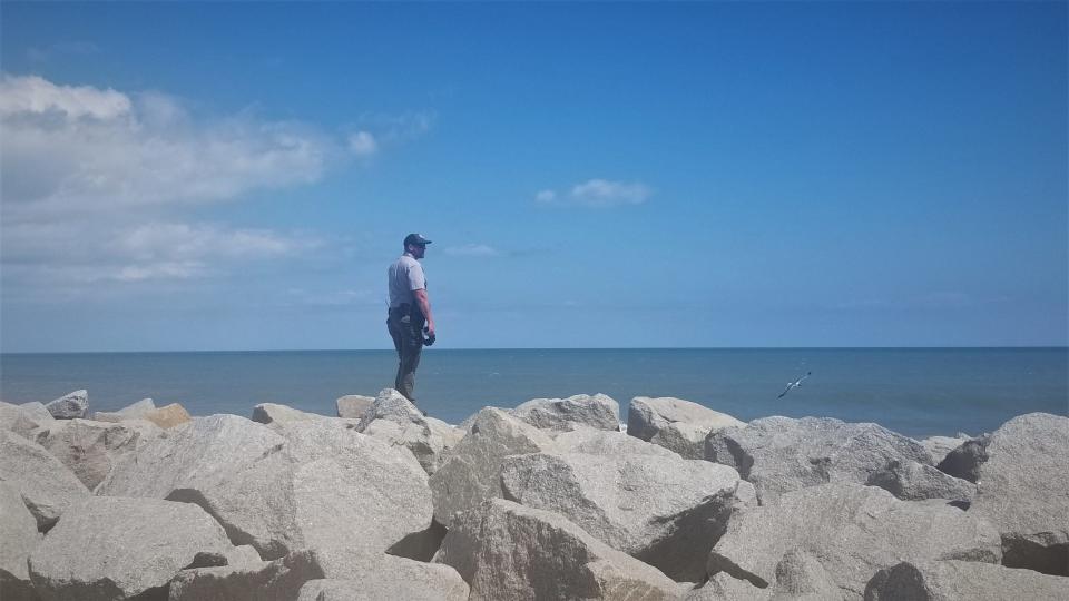 A park ranger observes the ocean at Fort Fisher. David Hernandez, a 16-year-old went missing Saturday while swimming.