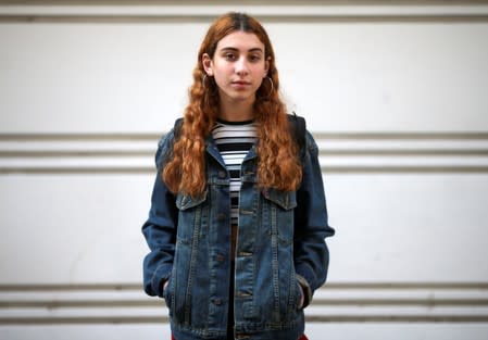 Lucila, 16, who voted for the first time in the primary elections, poses in Buenos Aires