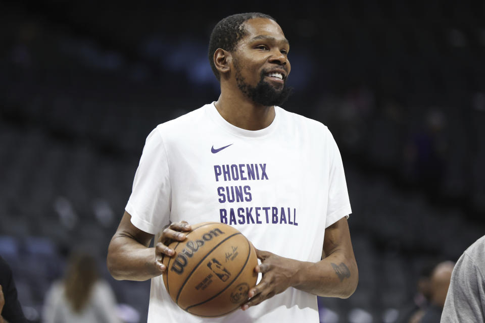 Phoenix Suns forward Kevin Durant gestures during warmups before an NBA basketball game against the Sacramento Kings Friday, April 12, 2024, in Sacramento, Calif. (AP Photo/Benjamin Fanjoy)