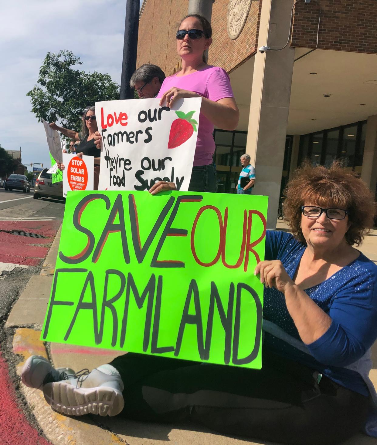 Residents protest against Hexagon Energy's planned solar farms set up outside the County-City building in South Bend, June 11, 2024.