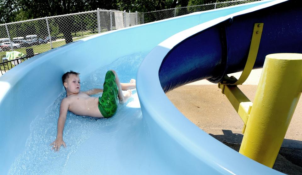 Brysyn Ayers, 9, of Riverton goes down the slide at the Nelson Center pool in Lincoln Park Tuesday June 14, 2022. 