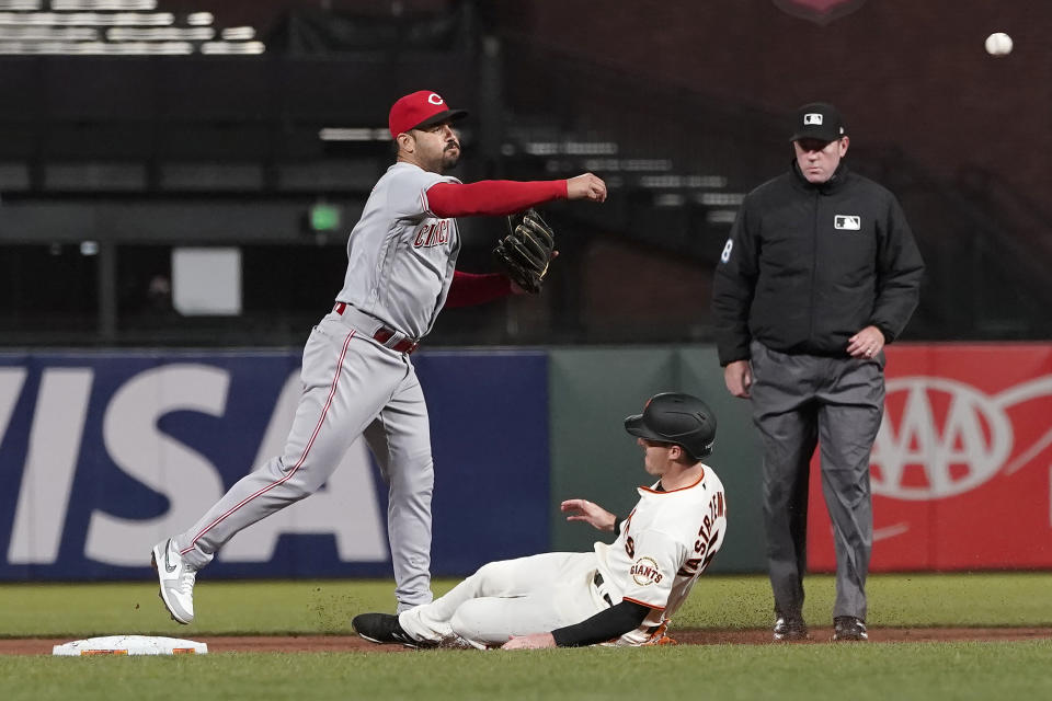 Cincinnati Reds shortstop Eugenio Suarez throws to first base after forcing out San Francisco Giants' Mike Yastrzemski at second base on a double play hit into by Alex Dickerson during the fifth inning of a baseball game in San Francisco, Tuesday, April 13, 2021. (AP Photo/Jeff Chiu)