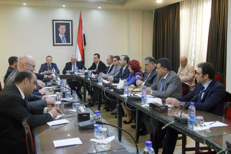 Syrian members of the Arab and foreign affairs committee at the People’s Assembly meet with members of the far-right Alternative for Germany (AfD) in Syria March 6, 2018. SANA/Handout via REUTERS