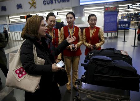 Ursula Gauthier, a reporter for the French current affairs magazine L'Obs, arrives at Beijing international airport for departure to France, in Beijing December 31, 2015. Gauthier is being forced to leave China after the government said it would not renew her press credentials for the new year in response to a critical report on Beijing's policies in the troubled western region of Xinjiang. REUTERS/Kim Kyung-Hoon
