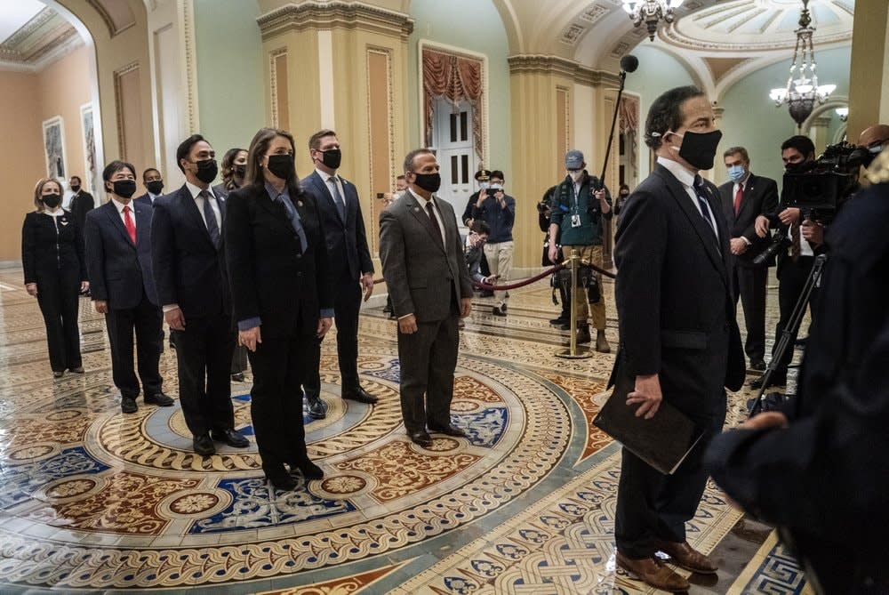 In this Jan. 25, 2021, file photo, Democratic House impeachment managers stand before entering the Senate Chamber as they deliver to the Senate the article of impeachment alleging incitement of insurrection against former President Donald Trump, in Washington From right to left are, Rep. Jamie Raskin, D-Md., Rep. Diana DeGette, D-Colo., Rep. David Cicilline, D-R.I., Rep. Joaquin Castro, D-Texas, Rep. Eric Swalwell, D-Calif., Rep. Ted Lieu, D-Calif., Del. Stacey Plaskett, D-Virgin Islands, Rep. Joe Neguse, D-Colo., and Rep. Madeleine Dean, D-Pa. (Melina Mara/The Washington Post via AP, Pool)