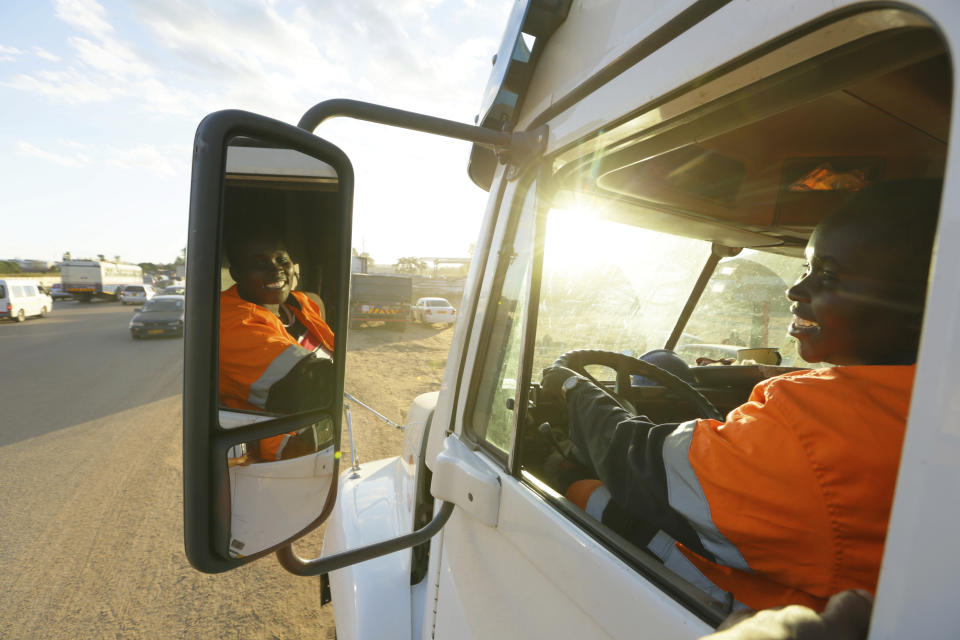 Molly Manatse a female truck driver is seen on the road in Harare, in this Saturday, March 6, 2021 photo. There are very few female truck drivers in Zimbabwe, but Manatse doesn't like to be singled out for her gender. From driving trucks and fixing cars to encouraging girls living with disability to find their places in society, women in Zimbabwe are refusing to be defined by their gender or circumstances, even as the pandemic hits them hardest and imposes extra burdens.(AP Photo/Tsvangirayi Mukwazhi)