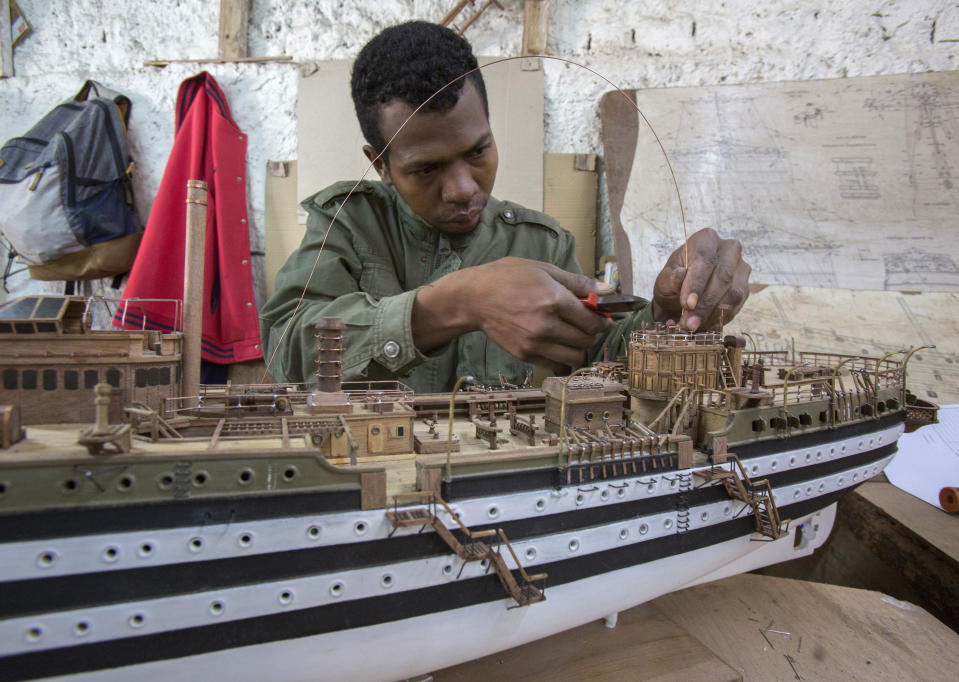 A Malagasy man builds a model ship at the Le Village model ship making company in Antananarivo, Madagascar, Wednesday, Sept. 11, 2024. (AP Photo/Alexander Joe)