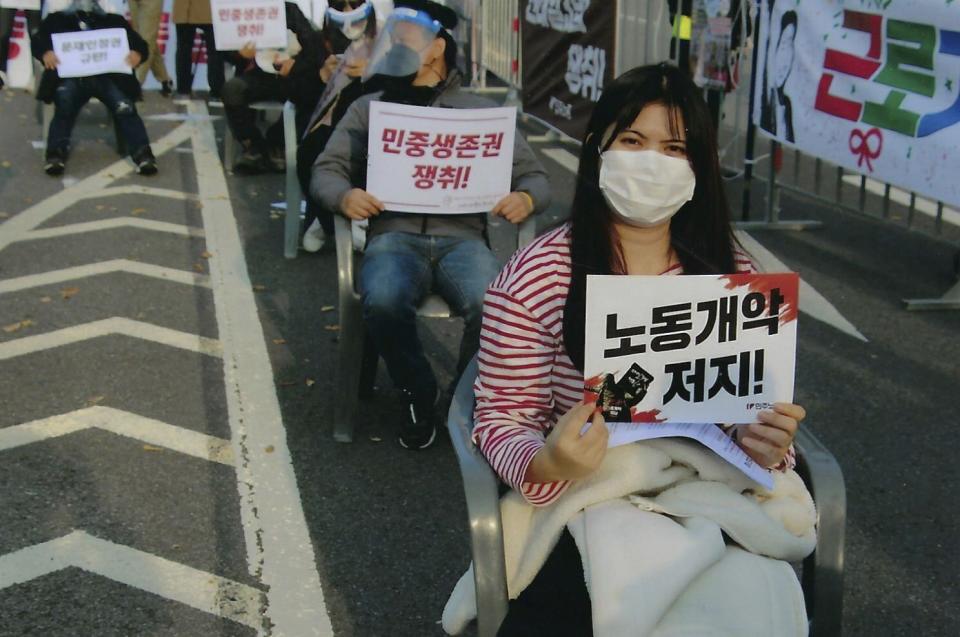 In this 2021 photo provided by Global Ministries, Global Mission Fellow Chirabhon Som-at attends a rally in South Korea to try to stop revisions to labor laws in Korea that will affect the migrant workers her organization serves. The International Mission Board is requiring its missionaries get the COVID-19 vaccine. The board is a Southern Baptist Convention agency and deploys thousands of evangelical missionaries across the globe. It says it implemented the new policy because of health risks and the need to show proof of vaccination in more places. (Global Ministries via AP)