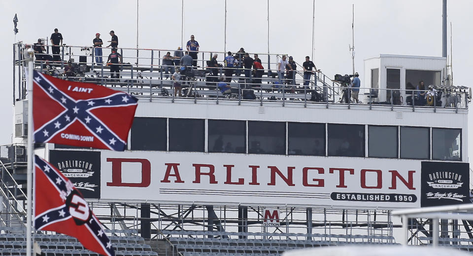 Confederate themed flags fly in the infield before a NASCAR Xfinity auto race at Darlington Raceway in Darlington, S.C., Saturday, Sept. 5, 2015. (AP Photo/Terry Renna)