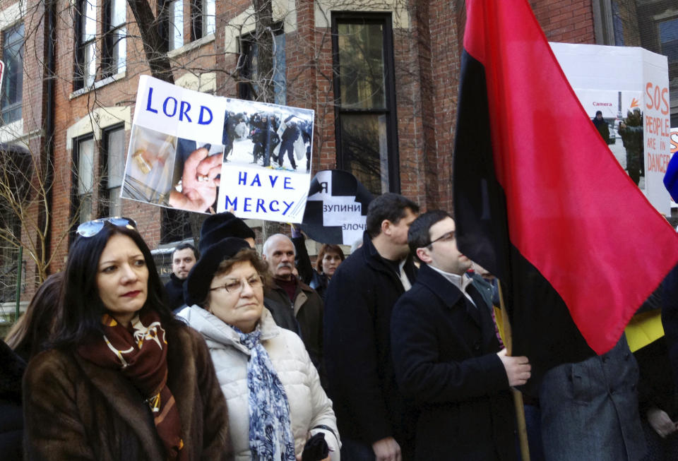 CORRECTS TO UKRAINIAN CONSULATE INSTEAD OF EMBASSY - Ukrainians gather outside the Ukrainian embassy in Chicago, Wednesday, Feb. 19, 2014, to protest the deadly violence in the capital of Kiev and call for a stronger response by the United States and the European Union. Clashes on Tuesday left 25 people dead in the worst violence in nearly three months of anti-government protests in Ukraine's capital. Protests began after the president backed away from a deal to join the European Union. (AP Photo/Tammy Webber)