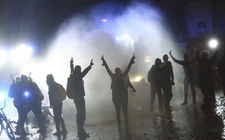 Riot police uses water cannons against protesters in the Schanze district of Hamburg following the G20 summit in Hamburg, July 9, 2017. REUTERS/Kai Pfaffenbach