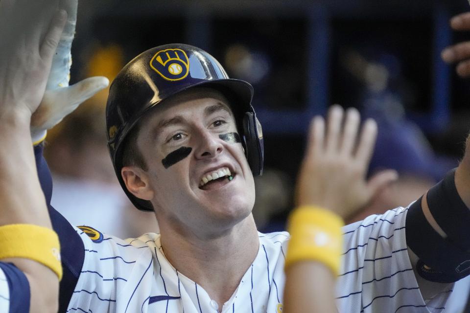 Milwaukee Brewers' Mark Canha is congratulated after hitting a home run during the third inning of a baseball game against the Philadelphia Phillies Sunday, Sept. 3, 2023, in Milwaukee. (AP Photo/Morry Gash)