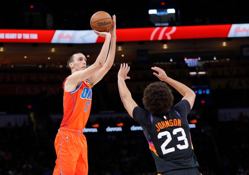 Thunder center Aleksej Pokusevski (17) shoots as Suns forward Cameron Johnson (23) defends during the second quarter of OKC's 117-96 win Sunday night at Paycom Center.