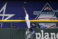 Texas Rangers center fielder Eli White leaps to the top of the wall to catch a flyout by Tampa Bay Rays' Ji-Man Choi in the first inning of a baseball game, Monday, May 30, 2022, in Arlington, Texas. (AP Photo/Tony Gutierrez)