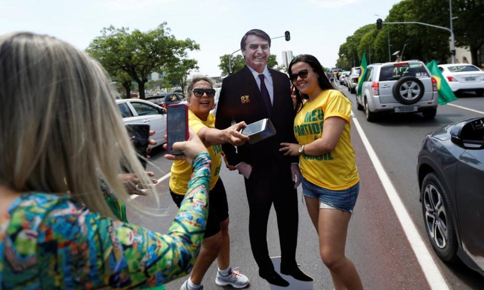 Supporters Jair Bolsonaro pose for picture in Brasilia on Saturday.