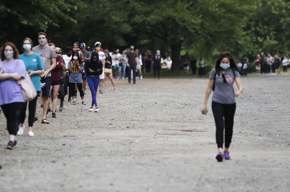 People wait in line to vote in the Georgia's primary election at Park Tavern on Tuesday, June 9, 2020, in Atlanta. (AP Photo/Brynn Anderson)