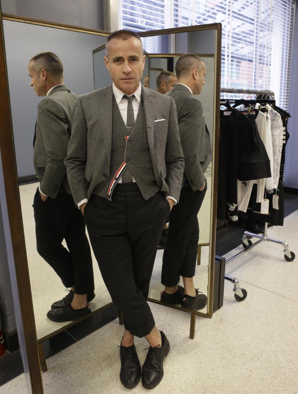 Fashion designer Thom Browne poses for a photograph at his Hudson Street store in New York, Wednesday, Feb. 20, 2013. Browne is building a business _ and what he hopes is a smart, long-lasting business at that. He's just not the overzealous, mercurial artiste. (AP Photo/Kathy Willens)