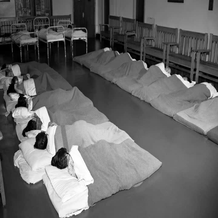 People of all ages sleep on mattresses on the ground circa 1946 at Letchworth Village in New York, New York