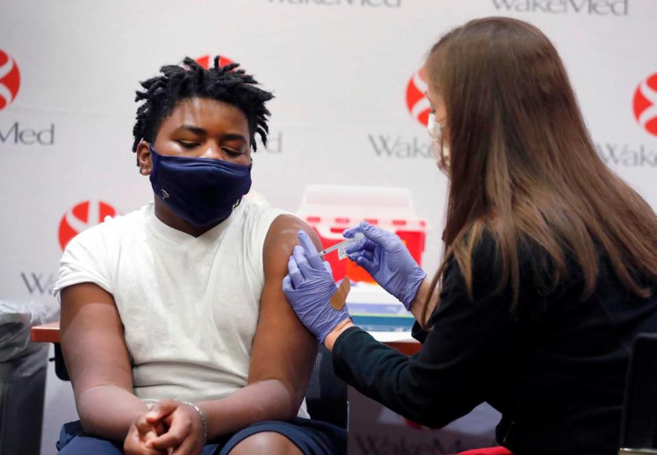 Gavin McLawhorn, 12, of Wake Forest receives his first COVID-19 vaccine shot at WakeMed Raleigh Campus on May 13, 2021. New research from Iowa State University suggests that exercising after getting the COVID-19 vaccine could boost the body’s immune response.