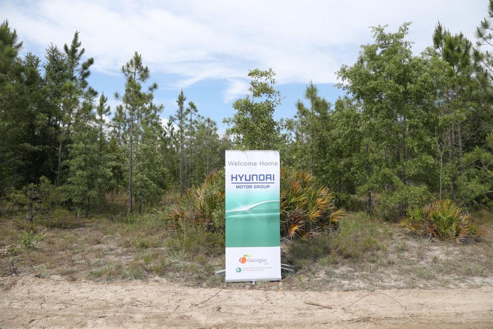 A banner welcomes Hyundai Motor group to their future home at the Bryan County mega-site. The property mostly consists of dirt roads and undeveloped land.