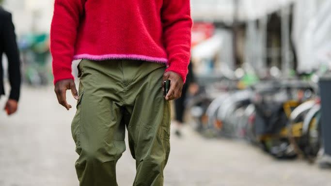 tyrod taylor wearing a red and pink sweater with green pants on the street in paris in a roundup of the best valentine's day gifts for him 2024