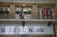 A passengers waits at Eurostar Terminal of the Gare du Nord train station in Paris, Friday, Aug. 14, 2020. British holidaymakers in France were mulling whether to return home early Friday to avoid having to self-isolate for 14 days following the U.K. government's decision to reimpose quarantine restrictions on France amid a recent pick-up in coronavirus infections. (AP Photo/Michel Euler)