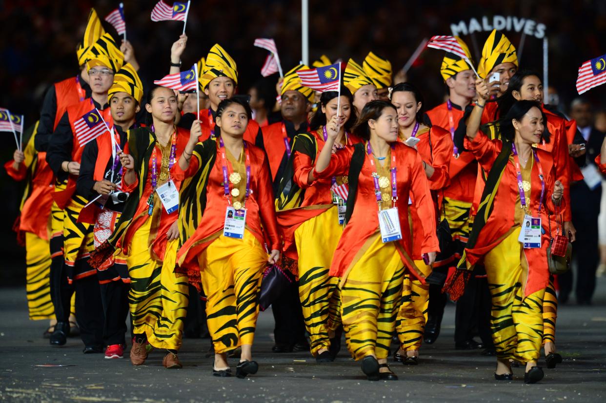 Members of Malaysia's delegation parade during the opening ceremony of the London 2012 Olympic Games in the Olympic Stadium in London on July 27, 2012.     AFP PHOTO / OLIVIER MORIN        (Photo credit should read OLIVIER MORIN/AFP/GettyImages)