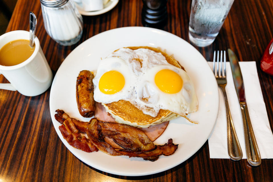 A plate of pancakes, eggs, bacon, sausage