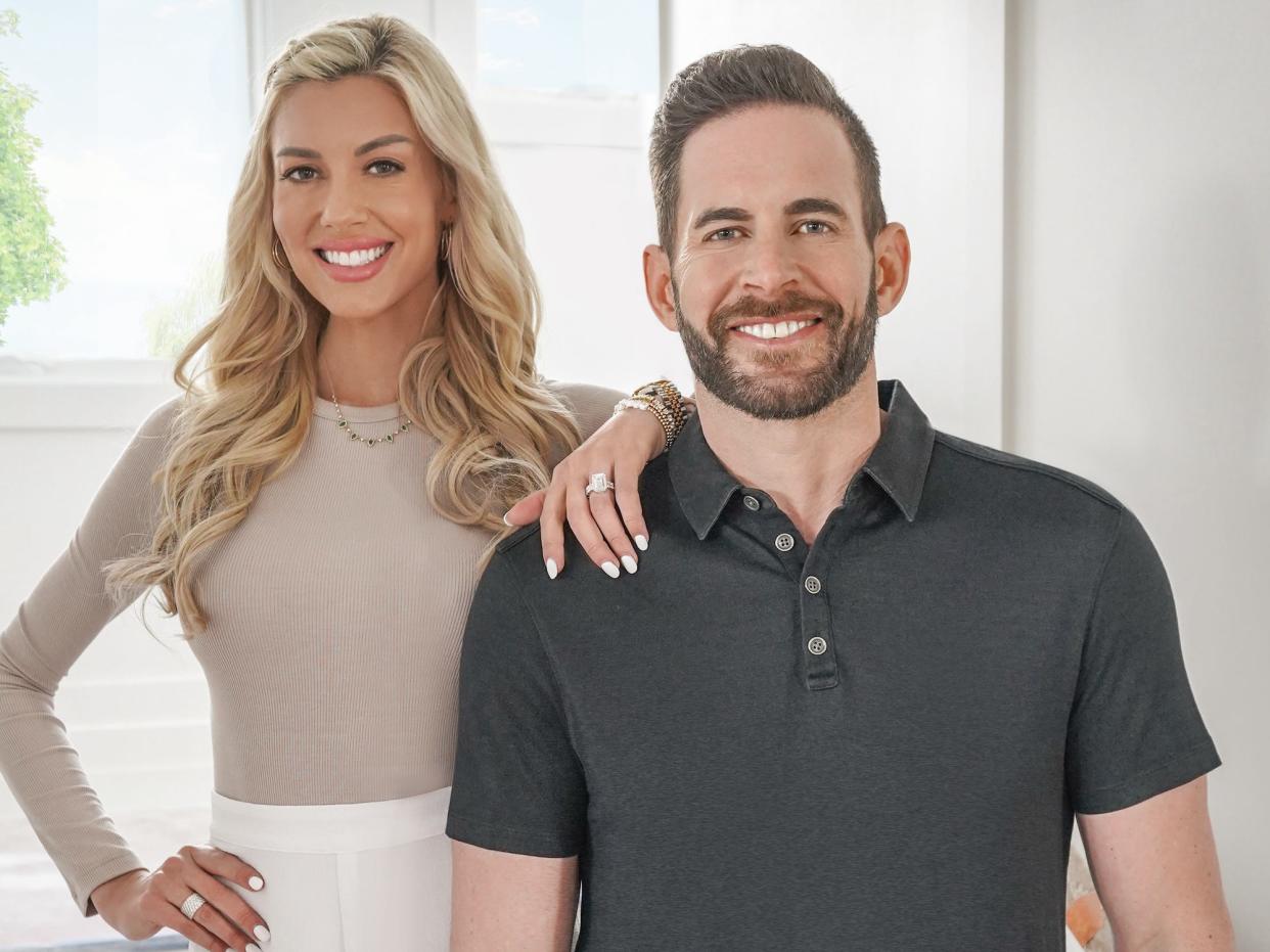 Heather Rae El Moussa and Tarek El Moussa pose for a photo.