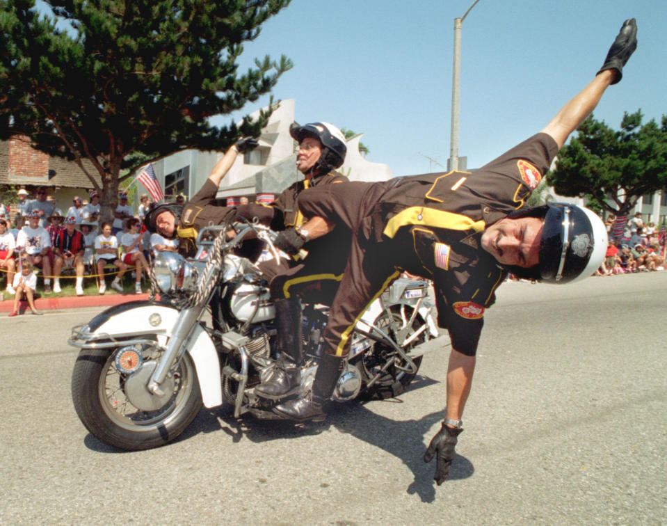 <p>Motorcycle stunts are performed by a precision drill team during the 92nd annual Huntington Beach 4th of July Parade in Calif., 1996. (Photo: Bob Grieser/Los Angeles Times via Getty Images) </p>