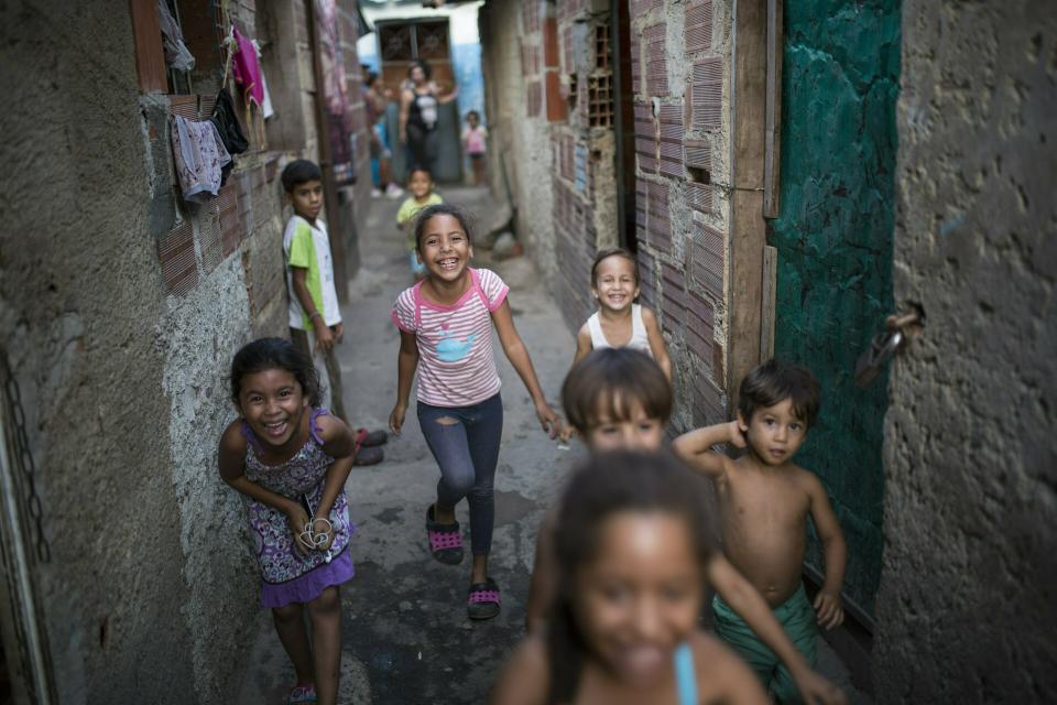 Children play at Los Hijos de Dios settlement, once an empty field owned by the government now occupied by about 60 families, in Caracas, Venezuela, Wednesday, May 8, 2019. More than 3 million Venezuelans have left their homeland in recent years amid skyrocketing inflation and shortages of food and medicine. U.S. administration officials have warned that 2 million more are expected to flee by the end of the year if the crisis continues in the oil-rich nation. (AP Photo/Rodrigo Abd)