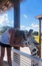 Missy Nowell gives Gerry a hug at her Oklahoma ranch. She bought the male giraffe at an auction when he was two months old, after he was rejected by his mother. (Missy Nowell)