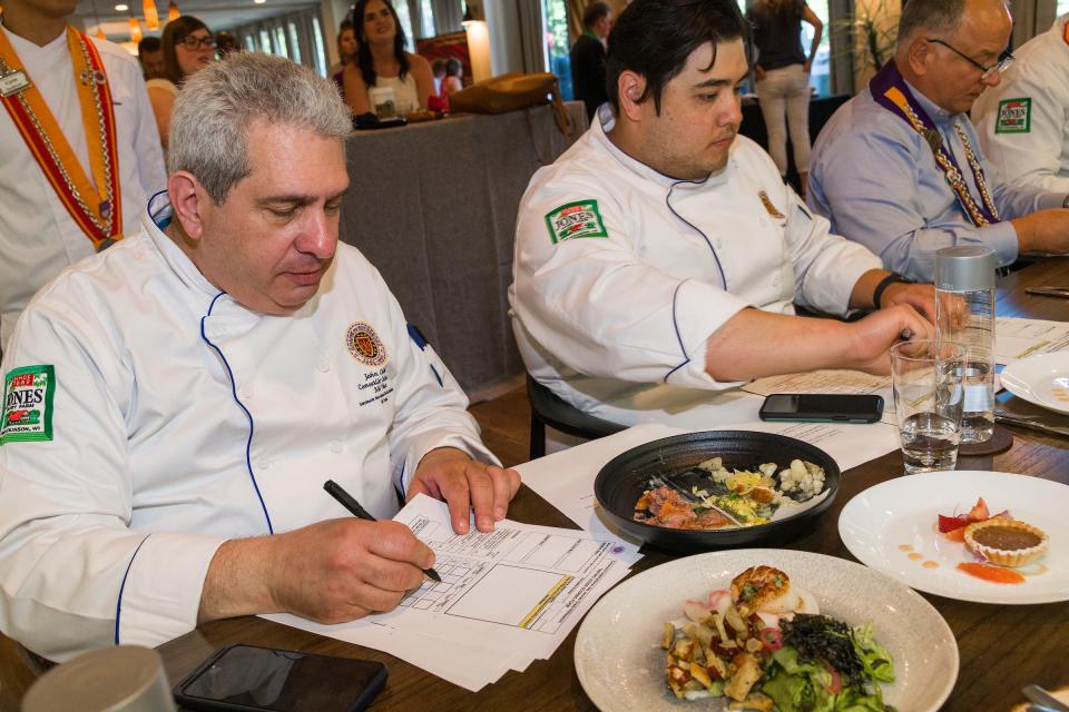 Judges grade the meals prepared by young chefs in the 2022 Jeunes Chefs Rotisseurs Competition in Atlanta.