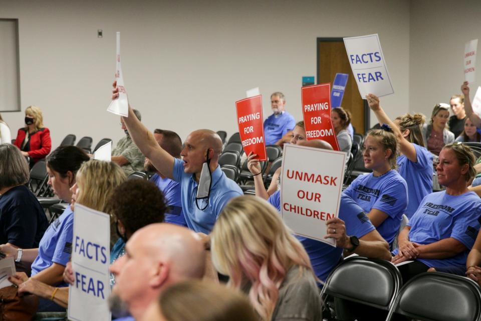 Holding signs, attendees voice their concerns with the board during a Tippecanoe School Corp. board meeting, Wednesday, Sept. 8, 2021 at the Greater Lafayette Career Academy in Lafayette.