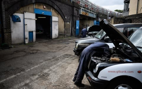 Working on taxis in Bow - Credit: Leon Neal/Getty Images Europe