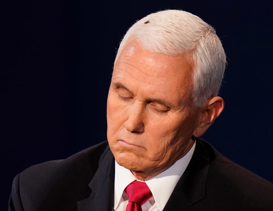 Vice President Mike Pence listens to Democratic vice presidential candidate Sen. Kamala Harris, D-Calif., during the vice presidential debate.