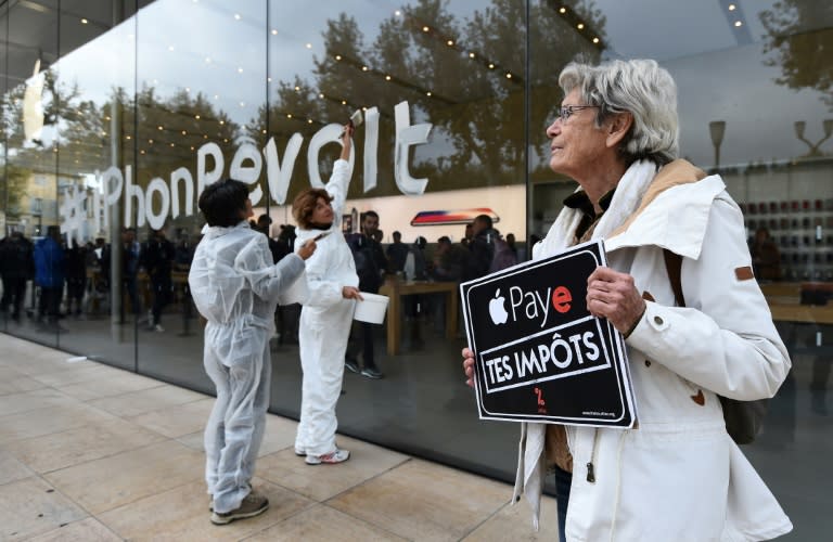 Protesters in France last week carried signs urging Apple to "pay your taxes" in a reference to its dispute with EU authorities over back taxes